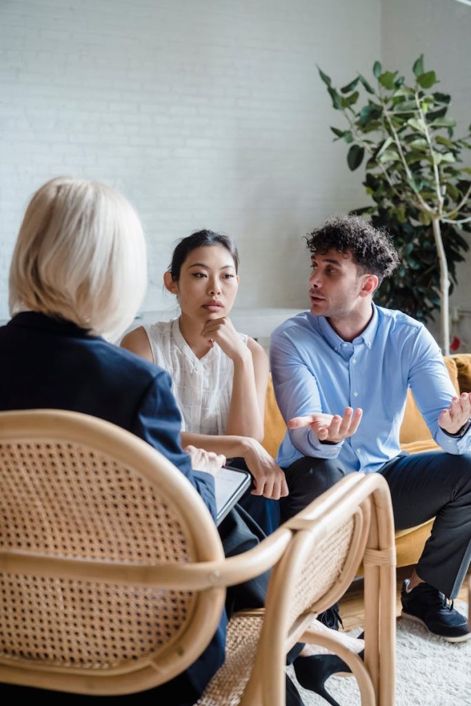 pexels-photo-8559997-8559997 A couple discusses issues with a therapist in a modern office setting.
